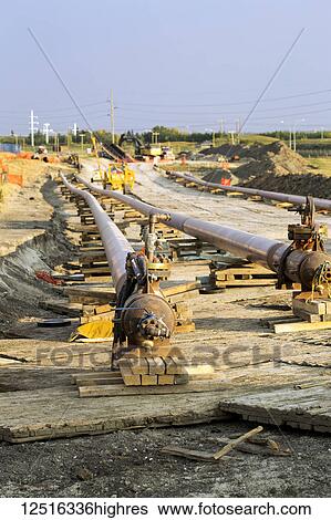 Stock Photograph - Twin pipeline under construction; Calgary, Alberta, Canada. Fotosearch