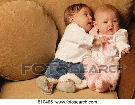 Stock Photography - Two babies sitting together. Fotosearch
