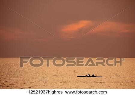 Two people in outrigger canoe at sunset; Kihei, Maui, Hawaii, United States of America View Large Photo Image Stock Photograph - Two people in outrigger canoe at sunset; Kihei, Maui, Hawaii, United States of America. Fotosearch