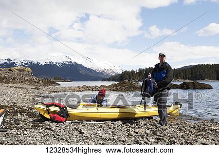 Two sea kayakers on shore with their boat, Kachemak Bay, South-central Alaska; Alaska, United States of America View Large Photo Image Stock Photograph - Two sea kayakers on shore with their boat, Kachemak Bay, South-central Alaska; Alaska, United States of America. Fotosearch