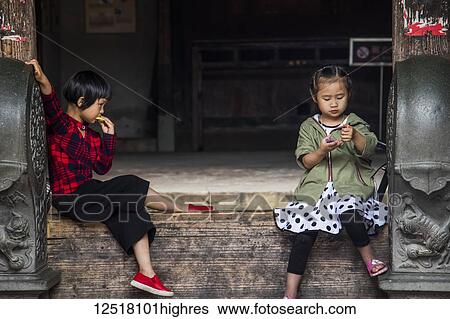 Two young girls in the Eryi Building, Dadi Tulou; Fujian, China View Large Photo Image Stock Photograph - Two young girls in the Eryi Building, Dadi Tulou; Fujian, China. Fotosearch