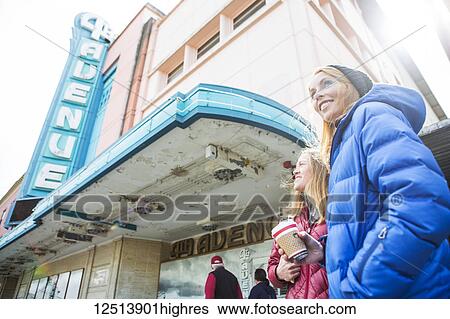 Stock Photograph - Two young women hanging out in downtown Anchorage, South-central Alaska; Anchorage, Alaska, United States of America. Fotosearch