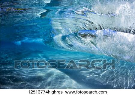 Underwater view of the blue water of the surf crashing over a sandy bottom; Maui, Hawaii, United States of America View Large Photo Image Stock Photograph - Underwater view of the blue water of the surf crashing over a sandy bottom; Maui, Hawaii, United States of America. Fotosearch