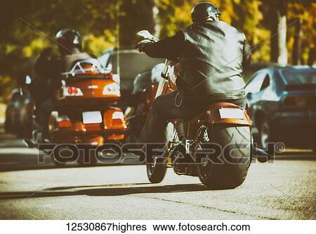 Stock Photograph - Very customized motorcycles traveling along a street during an event; Edmonton, Alberta, Canada. Fotosearch