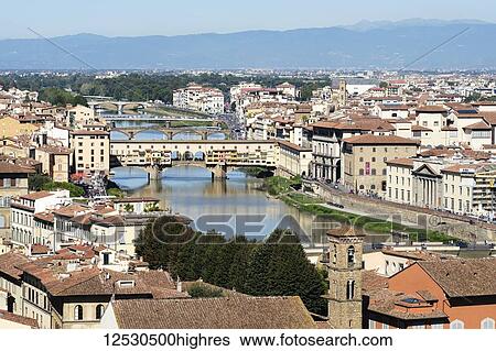 Stock Photograph - View down the River Ar0 towards the Ponte Vecchio in the middle distance; Florence, Tuscany, Italy. Fotosearch