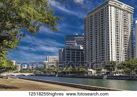 Stock Photograph - View North across Ala Wai Canal from Ala Wai Promenade towards Kalakaua Avenue bridge, Waikiki; Honolulu, Oahu, Hawaii, United States of America. Fotosearch