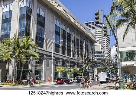 Stock Photograph - View North into Seaside Avenue from South side of Kalakaua Avenue with Waikiki Busines Plaza street level on the right in Waikiki; Honolulu, Oahu, Hawaii, United States of America. Fotosearch