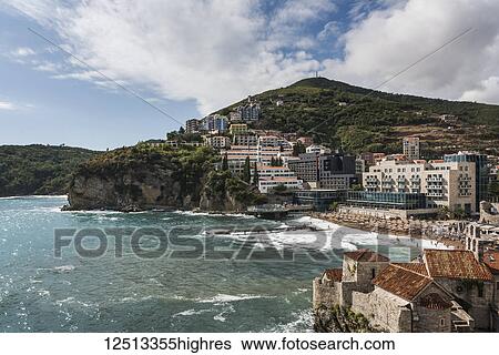 Stock Photograph - View of the town of Budva along the coast of Monte; Budva, Opstina Budva, Monte. Fotosearch