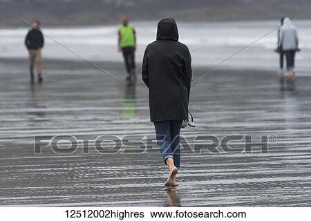 Walking on the wet sand of Cox Bay Beach, Pacific Rim National Park, Vancouver Island; Tofino, British Columbia, Canada View Large Photo Image Stock Photograph - Walking on the wet sand of Cox Bay Beach, Pacific Rim National Park, Vancouver Island; Tofino, British Columbia, Canada. Fotosearch