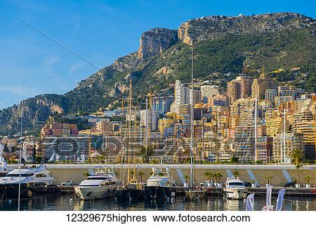Stock Photograph - Waterfront With Buildings And Boats In The Harbour; Monte Carlo, Monaco. Fotosearch