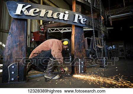 Welder And Metal Work Artist Doug Schwiesow Working On A Custom Sign Designed With A Local Artist For The Kenai Peninsula College Kachemak Bay Campus. View Large Photo Image Stock Photograph - Welder And Metal Work Artist Doug Schwiesow Working On A Custom Sign Designed With A Local Artist For The Kenai Peninsula College Kachemak Bay Campus.. Fotosearch