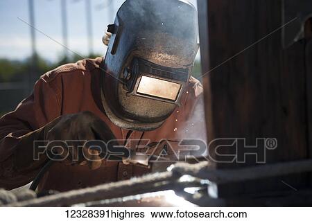 Welder And Metal Work Artist Doug Schwiesow Working On A Custom Sign Designed With A Local Artist For The Kenai Peninsula College Kachemak Bay Campus. View Large Photo Image Stock Photograph - Welder And Metal Work Artist Doug Schwiesow Working On A Custom Sign Designed With A Local Artist For The Kenai Peninsula College Kachemak Bay Campus.. Fotosearch