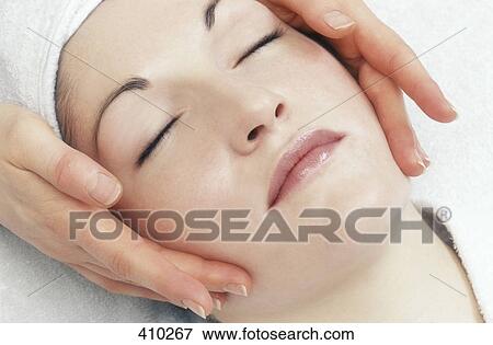 Woman getting a face massage View Large Photo Image Stock Photo - Woman getting a face massage. Fotosearch