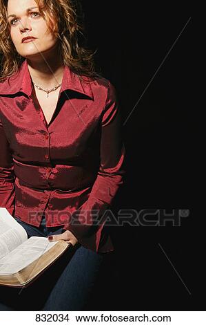 Picture - Woman holding Bible. Fotosearch
