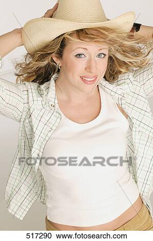 Woman holding hat View Large Photo Image Stock Image - Woman holding hat. Fotosearch
