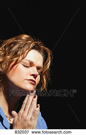 Stock Photo - Woman in prayer. Fotosearch