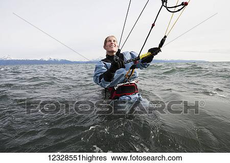 Woman in the water preparing to kitesurf, Kachemak Bay, South-central Alaska, USA View Large Photo Image Stock Photograph - Woman in the water preparing to kitesurf, Kachemak Bay, South-central Alaska, USA. Fotosearch