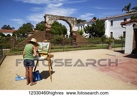 Woman Painting The Scene On An Easel In A Courtyard At Mission San Luis Rey, Near Oceanside, Ca In Late Summer; California, United States Of America View Large Photo Image Stock Photograph - Woman Painting The Scene On An Easel In A Courtyard At Mission San Luis Rey, Near Oceanside, Ca In Late Summer; California, United States Of America. Fotosearch