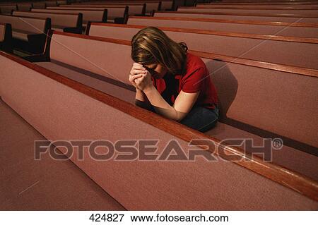 Woman praying in a church pew View Large Photo Image Stock Photo - Woman praying in a church pew. Fotosearch