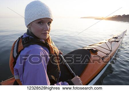 Stock Photograph - Woman sea kayaking in Kachemak Bay near Homer, Southcentral Alaska, USA. Fotosearch