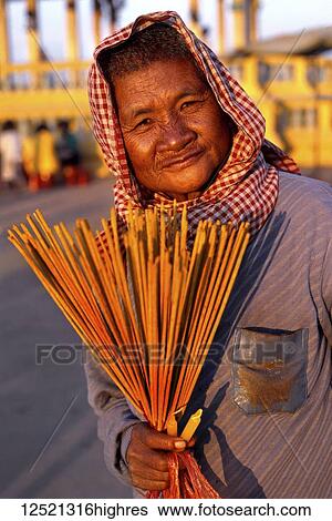 Woman selling incense and candles; Phnom Penh, Cambodia View Large Photo Image Stock Photograph - Woman selling incense and candles; Phnom Penh, Cambodia. Fotosearch