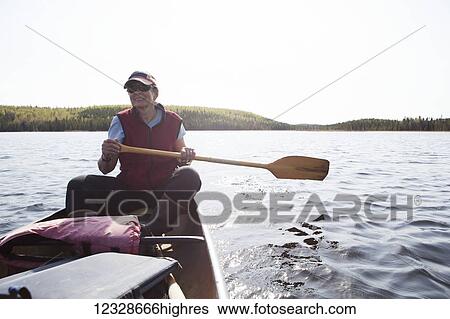 Woman steering a canoe in the Swanson Lake area, Kenai Peninsula, South-central Alaska; Alaska, United States of America View Large Photo Image Stock Photograph - Woman steering a canoe in the Swanson Lake area, Kenai Peninsula, South-central Alaska; Alaska, United States of America. Fotosearch