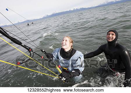 Stock Photograph - Woman taking instruction in a kitesurfing class, Kachemak Bay, South-central Alaska; Alaska, United States of America. Fotosearch