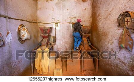 Woman working on a red pepper mill at the Medeber Market; Asmara, Central Region, Eritrea View Large Photo Image Stock Photograph - Woman working on a red pepper mill at the Medeber Market; Asmara, Central Region, Eritrea. Fotosearch