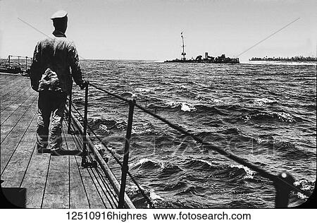 World war one image of a man standing on a ship's dock watching a another ship run aground, magic lantern slide View Large Photo Image Stock Photograph - World war one image of a man standing on a ship's dock watching a another ship run aground, magic lantern slide. Fotosearch