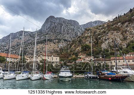 Stock Photograph - Yachts and sailboats mooring in the harbour in the Bay of Kotor; Kotor, Monte. Fotosearch