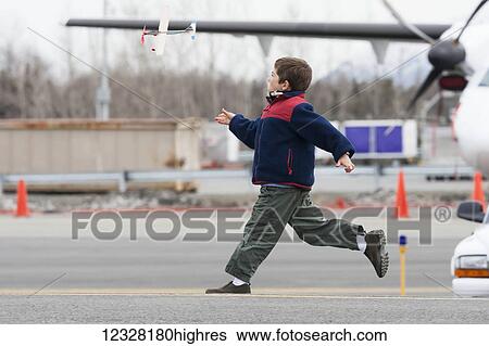 Young Boy Running On The Tarmac At The Alaska Airmen's Air Show, Alaska, USA View Large Photo Image Stock Photograph - Young Boy Running On The Tarmac At The Alaska Airmen's Air Show, Alaska, USA. Fotosearch