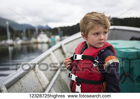 Young boy stands in his family's set-net skiff, South-central Alaska; Seldovia, Alaska, United States of America View Large Photo Image Stock Photograph - Young boy stands in his family's set-net skiff, South-central Alaska; Seldovia, Alaska, United States of America. Fotosearch