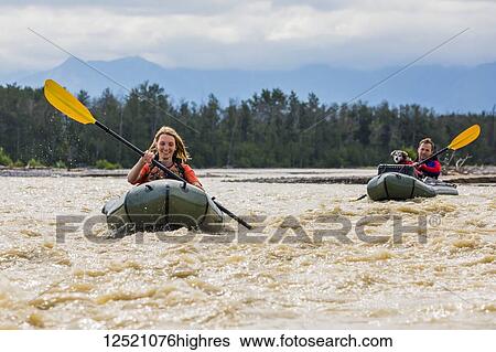 Young couple with their dog in pack rafts in Jarvis Creek, Interior Alaska; Alaska, United States of America View Large Photo Image Stock Photograph - Young couple with their dog in pack rafts in Jarvis Creek, Interior Alaska; Alaska, United States of America. Fotosearch