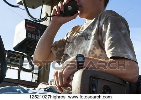 Young farmer on tractor radio, soybean harvest scene, near Nerstrand; Minnesota, United States of America View Large Photo Image Stock Photograph - Young farmer on tractor radio, soybean harvest scene, near Nerstrand; Minnesota, United States of America. Fotosearch
