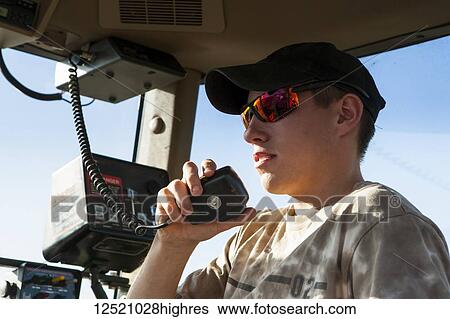 Young farmer on tractor radio, soybean harvest scene, near Nerstrand; Minnesota, United States of America View Large Photo Image Stock Photograph - Young farmer on tractor radio, soybean harvest scene, near Nerstrand; Minnesota, United States of America. Fotosearch