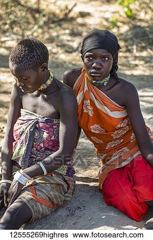 Stock Photograph - Young Hadzabe women in colourful clothing near Lake Eyasi; Tanzania. Fotosearch