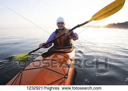 Young woman sea kayaking in Kachemak Bay, South-central Alaska, USA View Large Photo Image Stock Photograph - Young woman sea kayaking in Kachemak Bay, South-central Alaska, USA. Fotosearch