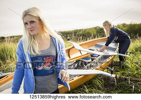 Young women preparing their wooden canoe, South-central Alaska; Homer, Alaska, United States of America View Large Photo Image Stock Photograph - Young women preparing their wooden canoe, South-central Alaska; Homer, Alaska, United States of America. Fotosearch