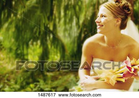 Stock Photo - A bride looks at her groom. Fotosearch