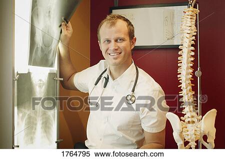 A doctor looks at an x-ray View Large Photo Image Stock Photography - A doctor looks at an x-ray. Fotosearch