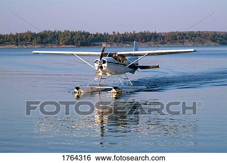 Stock Photograph - A float plane on water. Fotosearch