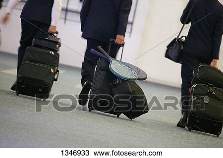 Stock Image - A group of businesspeople in the airport. Fotosearch