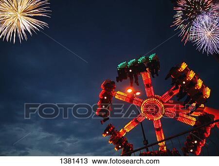 A spinning ride with fireworks display View Large Photo Image Stock Image - A spinning ride with fireworks display. Fotosearch