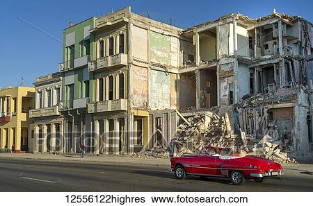 An old car passes the demolished facade of old buildings along a street; Havana, Cuba View Large Photo Image Stock Photograph - An old car passes the demolished facade of old buildings along a street; Havana, Cuba. Fotosearch