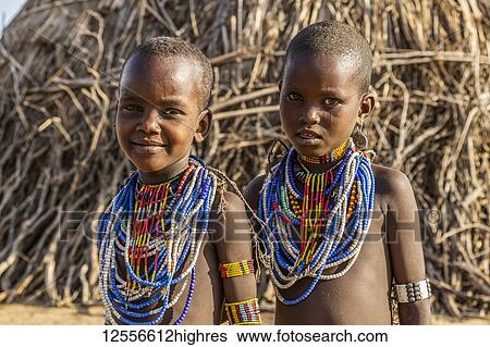 Stock Photograph - Arbore girls in Arbore Village, Omo Valley; Southern Nations Nationalities and Peoples' Region, Ethiopia. Fotosearch