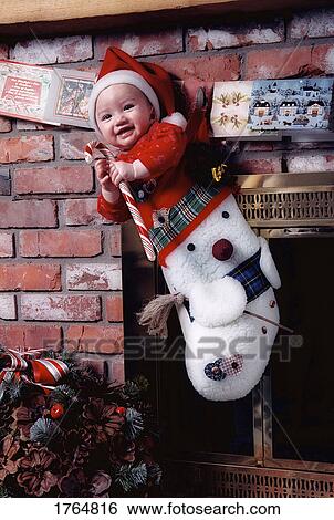 Stock Photograph - Baby in a Christmas Stocking. Fotosearch