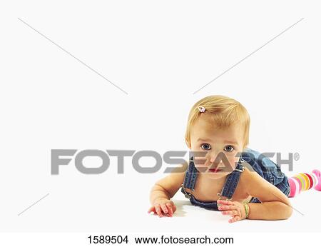 Picture - Baby lays on tummy. Fotosearch