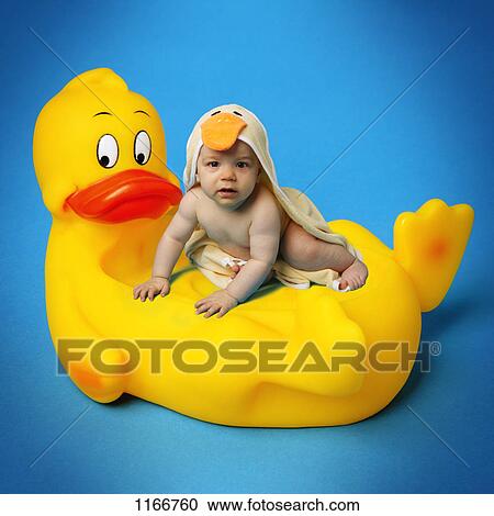Stock Image - Baby on a rubber ducky. Fotosearch