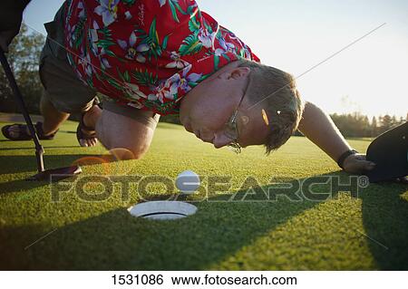 Blowing ball into the hole View Large Photo Image Stock Photograph - Blowing ball into the hole. Fotosearch