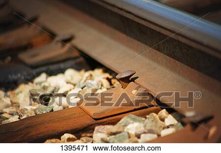 Stock Image - Bolts hold track in place. Fotosearch